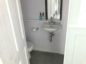 a white bathroom with a sink and a toilet at The Willows in Brighton & Hove