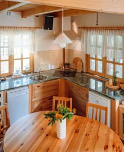 a kitchen with a wooden table and a wooden counter top at Kispatak Vendégház in Zebegény