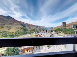 a view of a city from a balcony at Appartement rénové Au pied des pistes Balcon ouest - FR-1-344-769 in Les Menuires