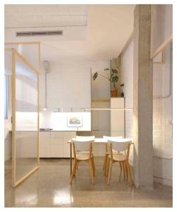 a dining room with a table and two chairs at Casa entera e independiente con parking en pleno centro de Sevilla in Seville