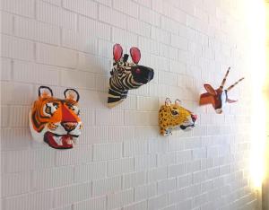 a wall with masks of animals on it at Casa entera e independiente con parking en pleno centro de Sevilla in Seville