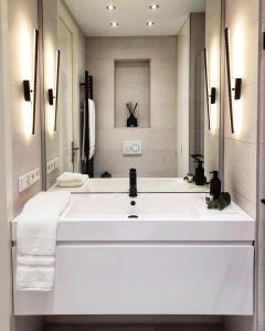 a white bathroom with a large white sink at New stylish 1 bedroom apt w/ 2 balconies in Centrum in Amsterdam