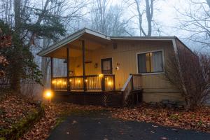 a small house with lights on the front of it at Pinetop Nest: Happy Place in Sugar Mountain in Banner Elk