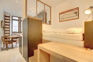 a small apartment with a bed and a dining room at Le Rousseau - Beautiful studio in Old Town in Annecy