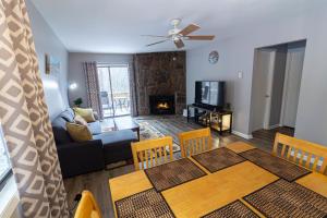 a living room and dining room with a table and a fireplace at Pinetop Nest: Happy Place in Sugar Mountain in Banner Elk +41 photos