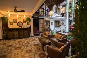 a large living room with couches and a table at Posada Mariposa Boutique Hotel - 5th Avenue in Playa del Carmen