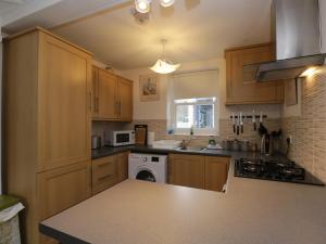 a kitchen with wooden cabinets and a counter top at 21 Entry Lane in Kendal