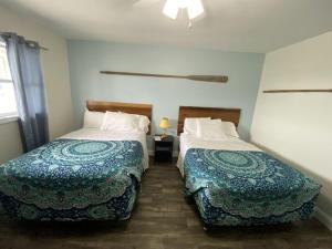 a hotel room with two beds and a window at Wachapreague Inn - Motel Rooms in Wachapreague