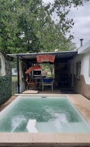a swimming pool in front of a house with a tent at HARD ROCK SERRANO in Santa María