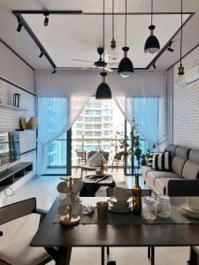 a living room with a table and a large window at Atlantis Residences 1BR By 360 HOME in Melaka