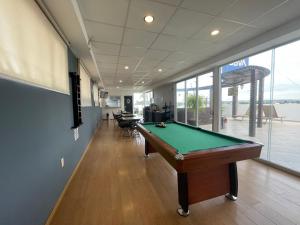 an office with a pool table in a room withwindows at My Home Suites in Celaya