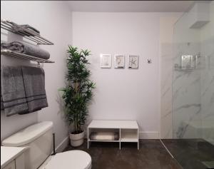 a white bathroom with a toilet and a shower at Cameo Hotel and Suites in Halifax