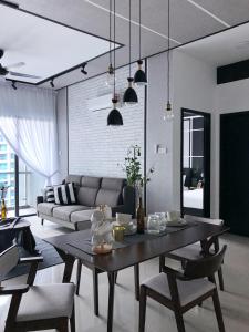 a living room with a table and a couch at Atlantis Residences 1BR By 360 HOME in Malacca
