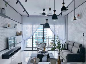 a living room with a couch and a large window at Atlantis Residences 1BR By 360 HOME in Malacca