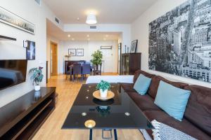 a living room with a couch and a table at APARTAMENTOS ARCOIRIS in Granada