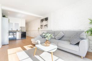 a living room with a couch and a table at LA CASA DEL RELOJ in Luanco