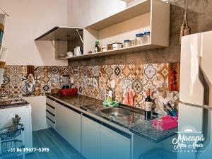 a kitchen with a sink and a counter top at FLATS MACAPÁ MEU AMOR 6 in Luis Correia