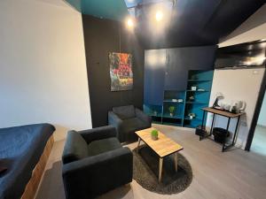 a living room with a couch and a table at M - Square Private Rooms in Skopje