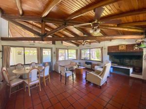 a living room with a table and chairs and a fireplace at La Alamanda in Federación