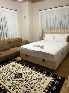 1 dormitorio con cama, sofá y alfombra en VILLA ECRİN, 