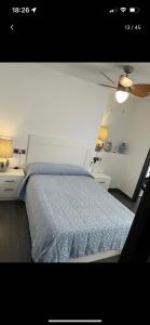 a bedroom with a bed with a blue comforter at Rondabella 3 Parking Gratis Centro in Ronda