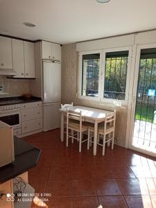 a kitchen with a table and chairs in it at Casa Las Bailas in Soria