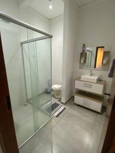 a bathroom with a glass shower and a sink at Imperial 2 Calçadão in Cornélio Procópio