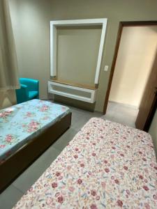 a small room with two beds and a mirror at Imperial 2 Calçadão in Cornélio Procópio