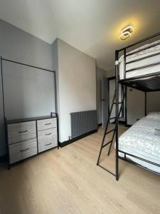 a bedroom with a bunk bed and a dresser at Newly refurbished 3 bedroom/2bathroom entire house in Lincoln