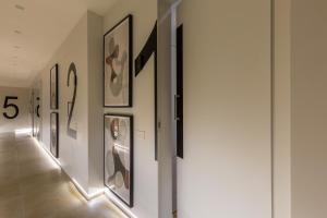 a hallway with framed art on the walls at Casa Lounge 43 in Cagliari