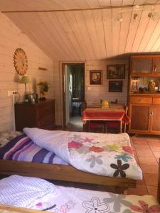 a bedroom with a bed and a table in a room at Duccio Cabana Hébergements Insolites in Potelle