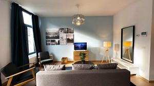 uma sala de estar com um sofá e um lustre em OneLuxStay near Fashion District em Antuérpia