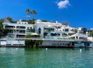 a large white building next to a body of water at Marina Palace Teques in Tequesquitengo