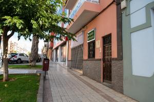 an empty sidewalk in a city with buildings at Aguere Nest Hostel in Las Lagunas