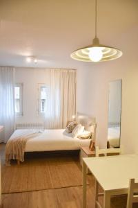 a bedroom with a bed and a mirror and a table at ESTUDIO AVET - Perfecta ubicación in Pas de la Casa