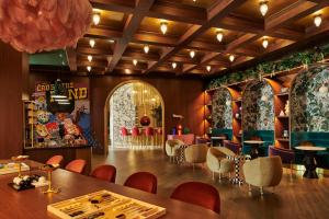 a dining room with a table and chairs at Virgin Hotels Dallas in Dallas