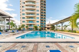 a swimming pool in front of a tall building at Luxurious 2BDR condo located in Prestigious Tower. in Santo Domingo