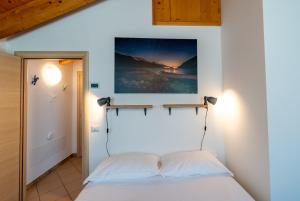 a bedroom with a bed and a painting on the wall at For Rest in Madesimo