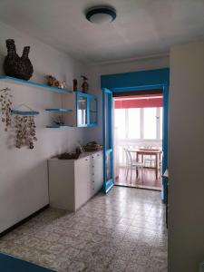 a kitchen with a table and a door to a dining room at Casa Mary in Marotta +5 photos