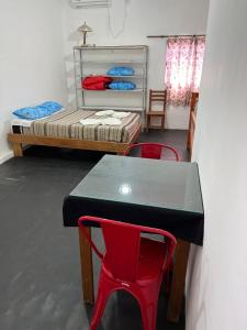 una habitación con una mesa y dos sillas y una cama en Departamento Sarmiento 1, en San Luis
