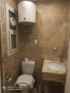 a small bathroom with a toilet and a sink at Salvatore Room With Breakfast-Sea View in Suez