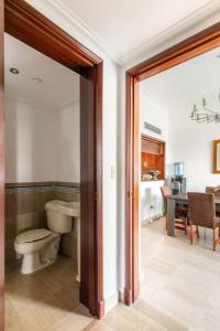 a bathroom with a toilet and a sink and a table at Luxurious 2BDR condo located in Prestigious Tower. in Santo Domingo