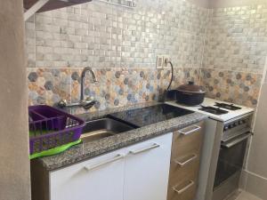 a kitchen with a sink and a pot on a stove at mi pesadilla2 in Salinas 