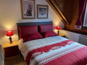 a bedroom with a large red bed with two lamps at Mandi Mandi a Tarvisio in Tarvisio