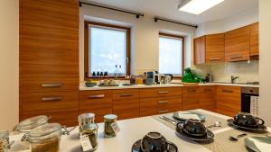 a kitchen with wooden cabinets and a counter top at For Rest in Madesimo