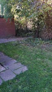 a walkway in the grass next to a brick building at Derbyallround in Herkingen