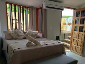 a bedroom with a large bed with a balcony at O Canto Pousada in Piranhas