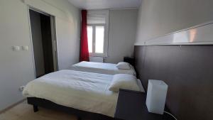 a bedroom with two beds and a window at Albert Studio's in Mechelen