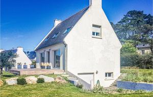 a white house with a black roof at Cozy Home In Plouarzel in Plouarzel +20 photos