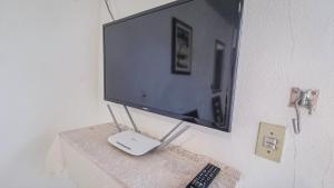 a flat screen tv sitting on top of a table at Casa Areal Boipeba in Ilha de Boipeba